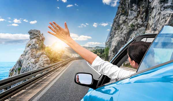 An image showing travellers enjoying driving through Croatia in a private car hire