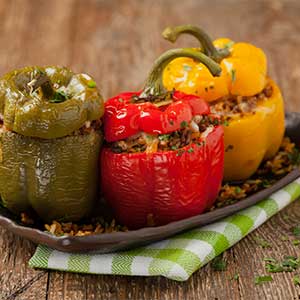 a plate of three stuffed peppers in a restaurant in croatia