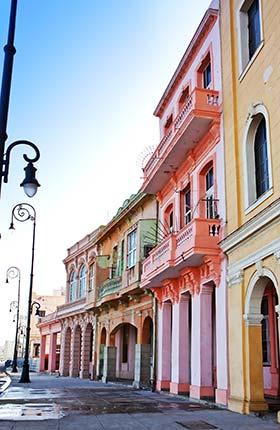 pastel coloured buildings on quiet street in old havana cuba