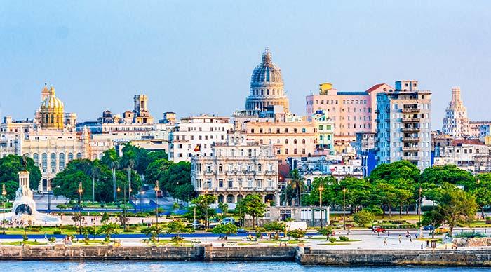 skyline of havana along the sea front with trees and buildings on group tour of Cuba