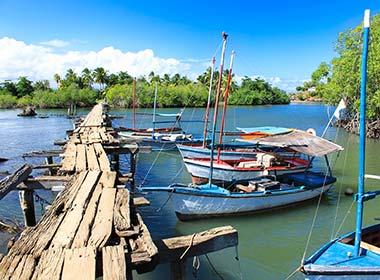 small fishing boats on the lake by wooden platform in baracoa cuba