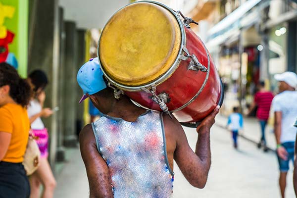 man carrying red drum on his back at havana carnival cuba