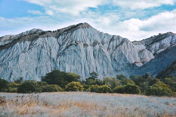 white sheer cliffs trees below and grasslands in javakheti national park georgia europe