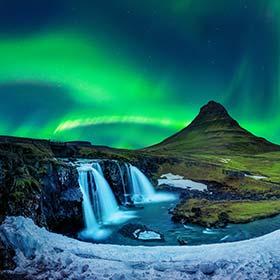 northern lights over kirkjufell mountain waterfalls and ice alongside