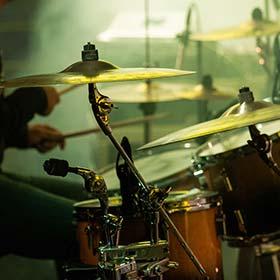 man playing the drums on a stage for icelands famous jazz festival