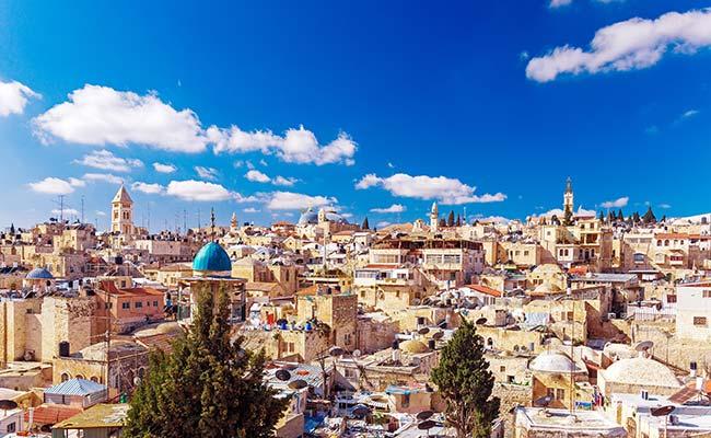 sunset view of jerusalem dominated by golden cupola of the dome of the rock whist visiting israel