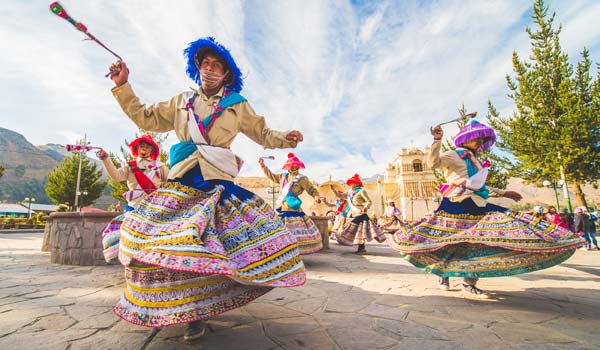 Adventure travelers discover local carnival parade with entertainers and dancers celebrating