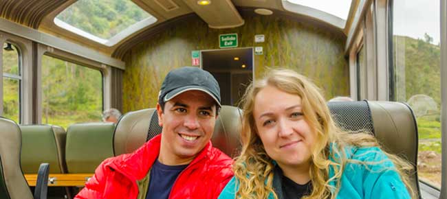 recent married couple on holiday on their honeymoon in peru on the train to aguas calientes near machu picchu 