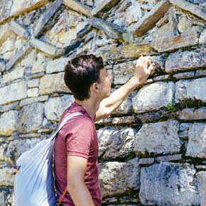 Solo traveler on a group tour at the ancient ruins of Kuelap