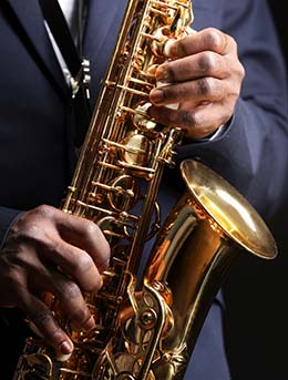 man playing saxophone at the nile gold jazz safari in kampala uganda