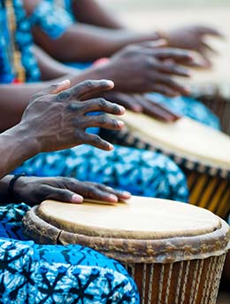 group of people playing traditional african drums at this is uganda festival in uganda