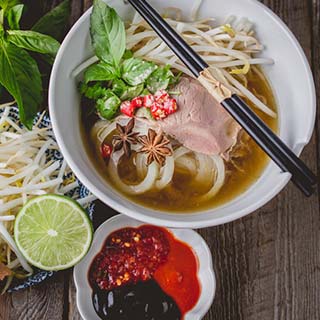 Pho Vietnamse noodle soup famous food on old wood