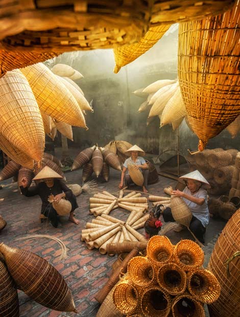 Local Vietnamese carftsmen making fish traps