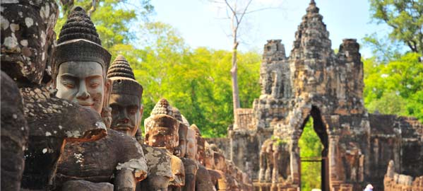 stone gate with ancient warrior statues leading up to the etrance of Ankor Thom, a huge highlight of Cambodia