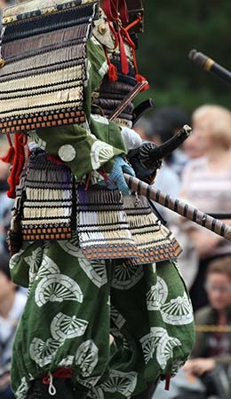 a parade of japanese wearing traditional dress celebrating kanda matsuri in Japan