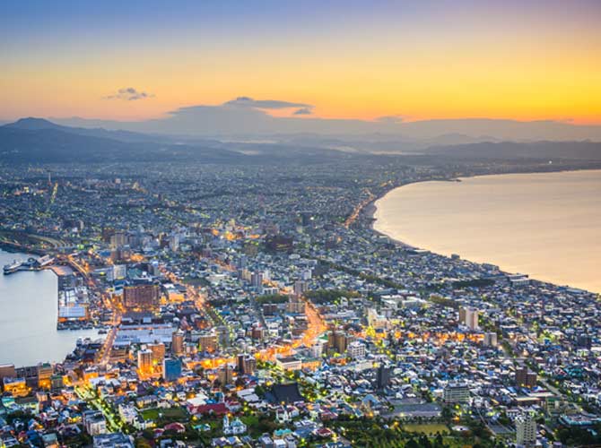 adventure travellers on top of Mt. Hakodate overlook Hokkaido skyline 