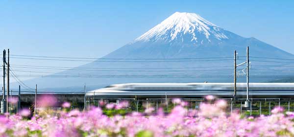 Shinkansen bullet train passes by Mount Fuji Yoshiwara