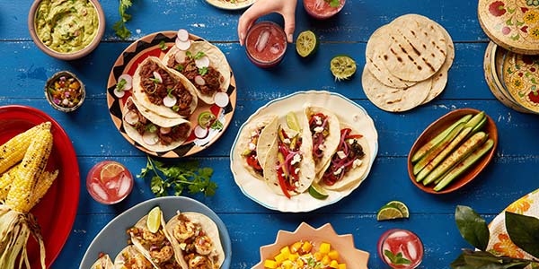 spread of mexican food on a blue table