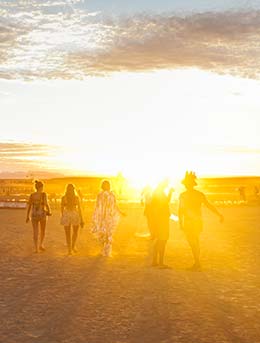 group of people walking through the desert for the afrikaburn music festival in south africa