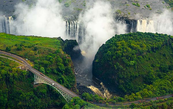 waterfall with greenery all around at victoria falls national park in zimbabwe