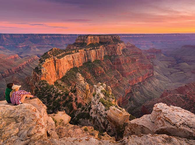 A couple overlooking the grand canyon in America