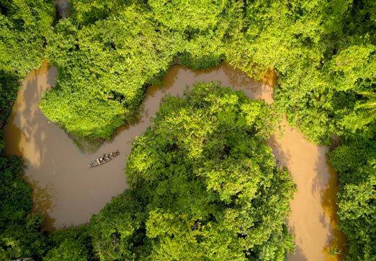 Tour group make their way on the Amazon River to their accomodation from Puerto Maldonado via river boat